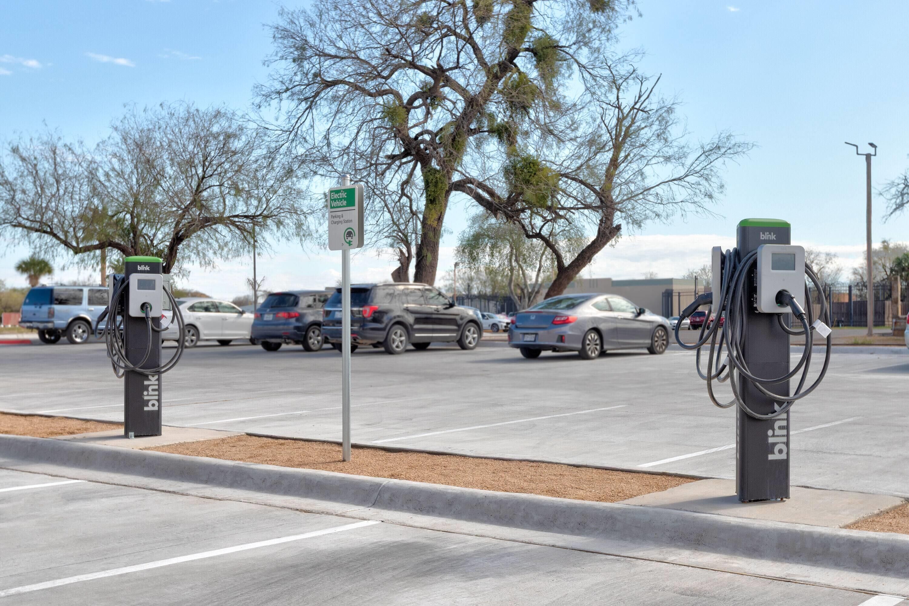 An electric vehicle charging station with a sign indicating it is for electric vehicles.