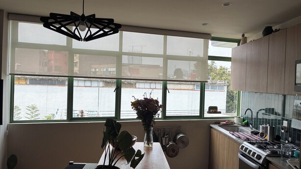 A modern kitchen with large windows, a wooden countertop, and a gas stove. - World Cup stay - Central location next to Condesa, Escandon neighborhoods. (Ciudad de México)