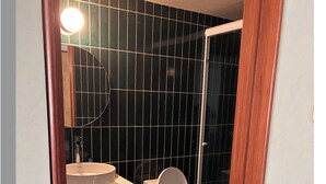 A bathroom with a toilet, sink, and wooden vanity. - World Cup stay - Central location next to Condesa, Escandon neighborhoods. (Ciudad de México)