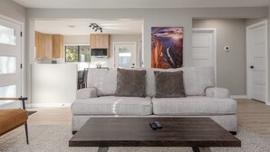 A modern living room with a sofa, a coffee table, and a TV. - The Desert Rose A Modern home in a great location (Sedona)
