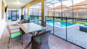 A covered patio area with a pool, outdoor furniture, and a view of the surrounding neighborhood. - BTR1463 (Davenport)