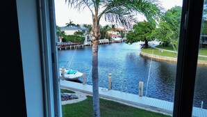 A view of a water body with a dock and a boat. - Stunning Waterfront Condo, Fully Remodeled – Bring Your Boat, No Fixed Bridges! (Boca Raton)