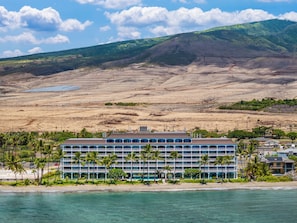 A hotel with multiple floors, a beach view, and palm trees. - Dream Vacation Studio by the Beach and Pool - Lahaina Shores 428 (Lahaina)