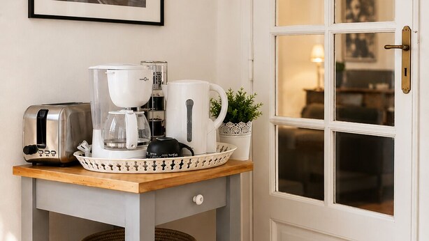 A kitchen area with a coffee maker, toaster, and a framed picture on the wall. - Quiet & spacious apartment - Secure bicycle garage - Fast WiFi (Saint-Quentin)