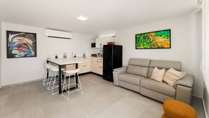 A modern apartment with a kitchen, dining area, and living room. - Isla Verde Ocean View | Entire 2nd Floor Suite (San Juan)