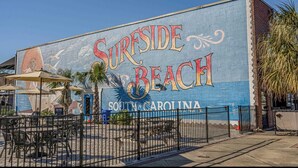 A mural of 'Surrside Beach' in South Carolina on a building. - Peaceful 2-bedroom condo at the beach with a water view! (Surfside Beach)