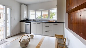 A modern kitchen with white cabinets, a dishwasher, and a window overlooking a garden. - Pet friendly home in Saint-Pierre-d'Oléron (Saint-Pierre-d'Oléron)