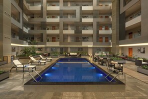 A multi-level indoor pool with lounge areas and seating. - Protea Hotel by Marriott Kinshasa (Kinshasa)