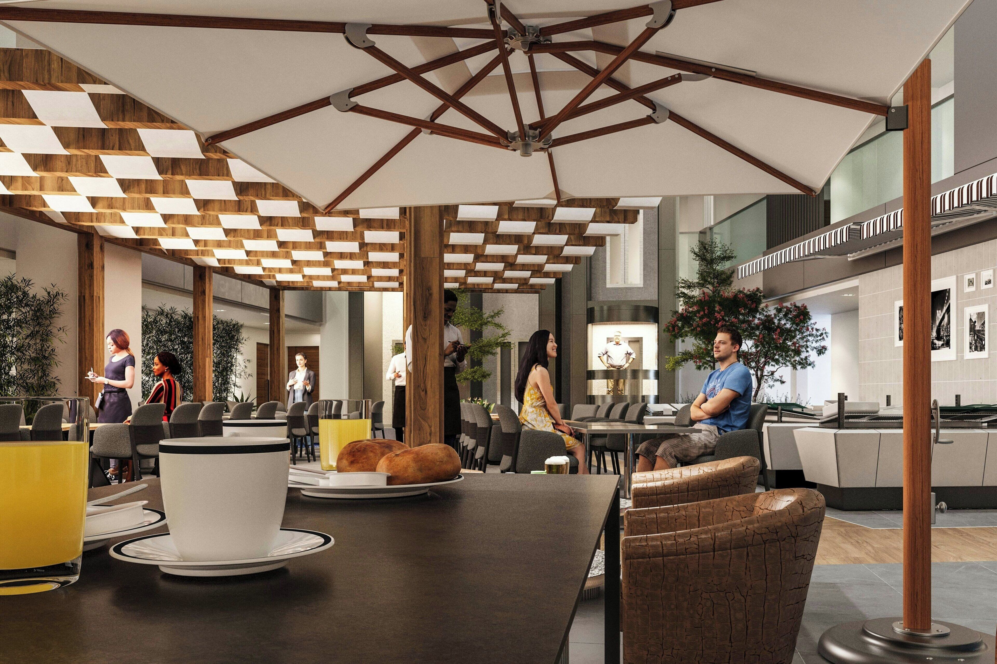 A modern indoor space with a central table, seating areas, and a ceiling with geometric wooden beams.