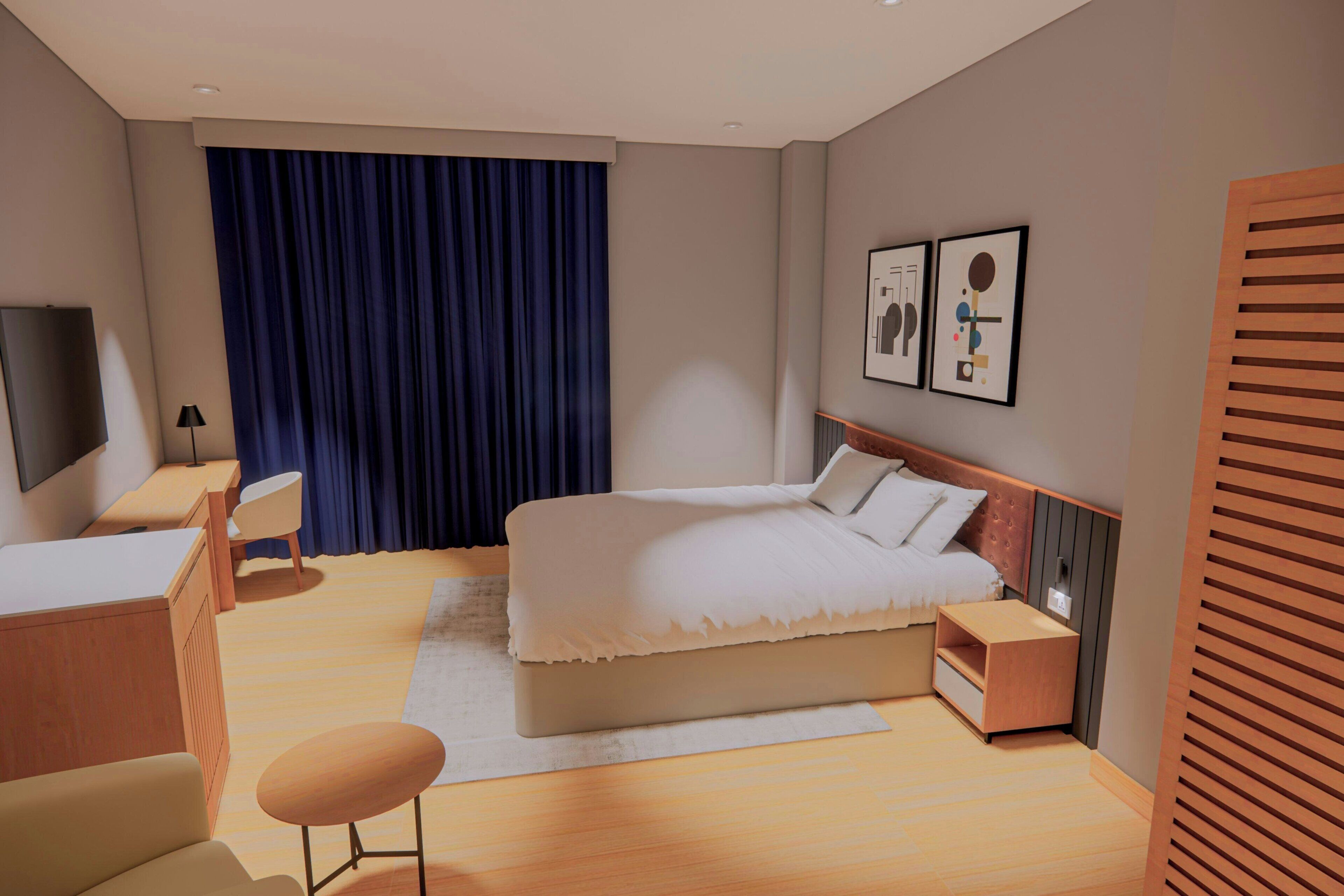 Una habitación de hotel moderna con una cama grande, mesitas de noche, un escritorio, una silla y una televisión.