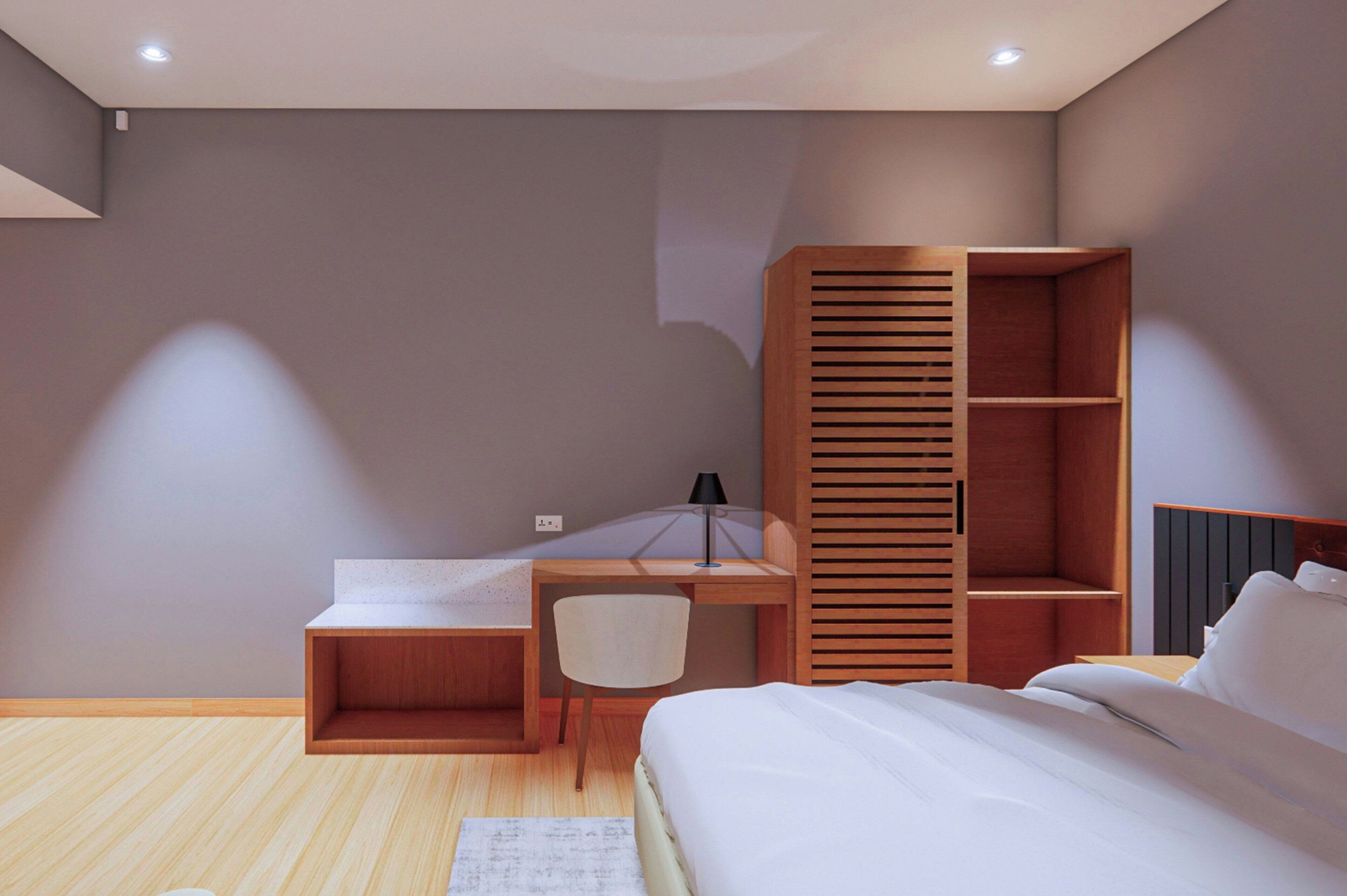 Un dormitorio moderno con cama, escritorio y armario empotrado.