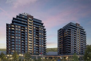 A modern high-rise building with multiple balconies and a rooftop terrace. - Marriott Executive Apartments Istanbul Tema World (Istanbul)