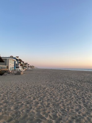 Een strand met een rij gebouwen.
