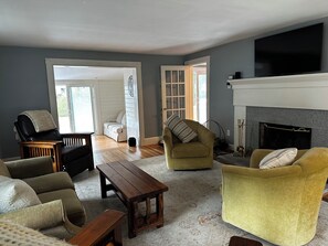 Smart TV, fireplace, books, computer monitors