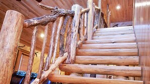 Una escalera de madera de diseño rústico, construida con troncos y ramas.