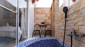 A small bathroom with a tiled floor, a shower, a sink, and a table with chairs. - Entire Villa 4 Bed room with private pool+Free wi-fi (Siem Reap)
