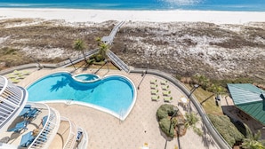 A resort with a large swimming pool, beach access, and a view of the ocean. - Spanish Key 301 | Steps from Flora Bama | Pools, Hot Tub | My Beach Getaways (Pensacola)