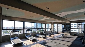 A gym with treadmills, stationary bikes, and exercise equipment. - NewExclusive Apartment Downtown, GYM, POOL&MORE 407 (Santo Domingo)