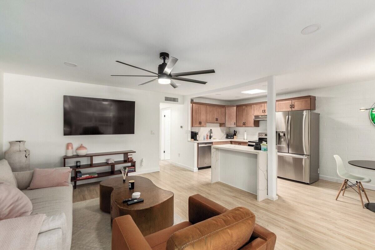 A modern apartment with a living room, kitchen, and dining area.