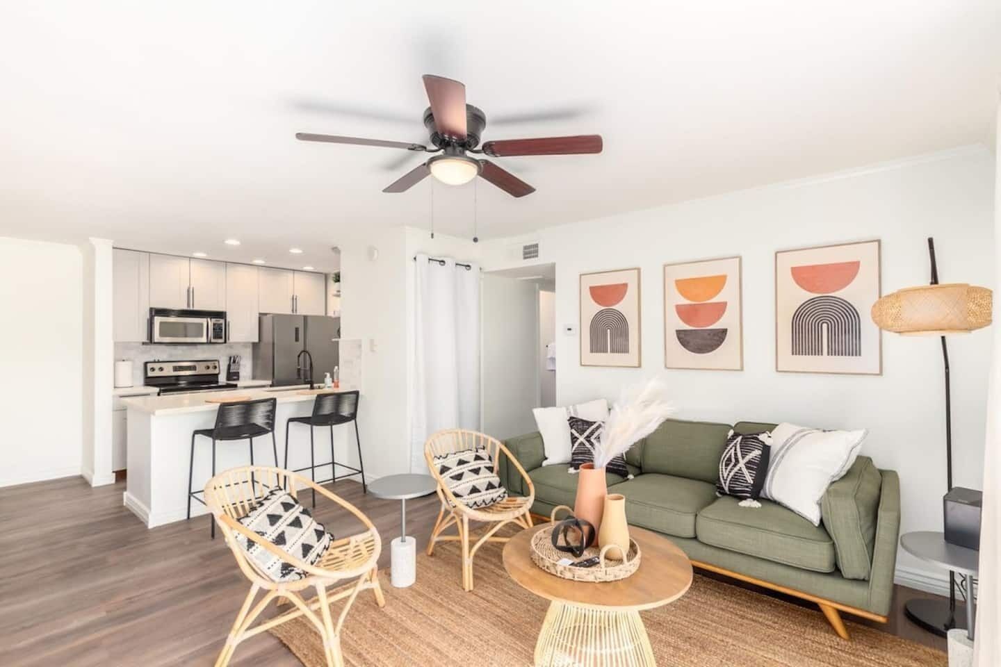 A modern apartment with a kitchen, dining area, and living room.
