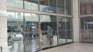 A modern building with large glass windows and a sign that reads "Prime Work." - Dolphins Tech (Salvador)