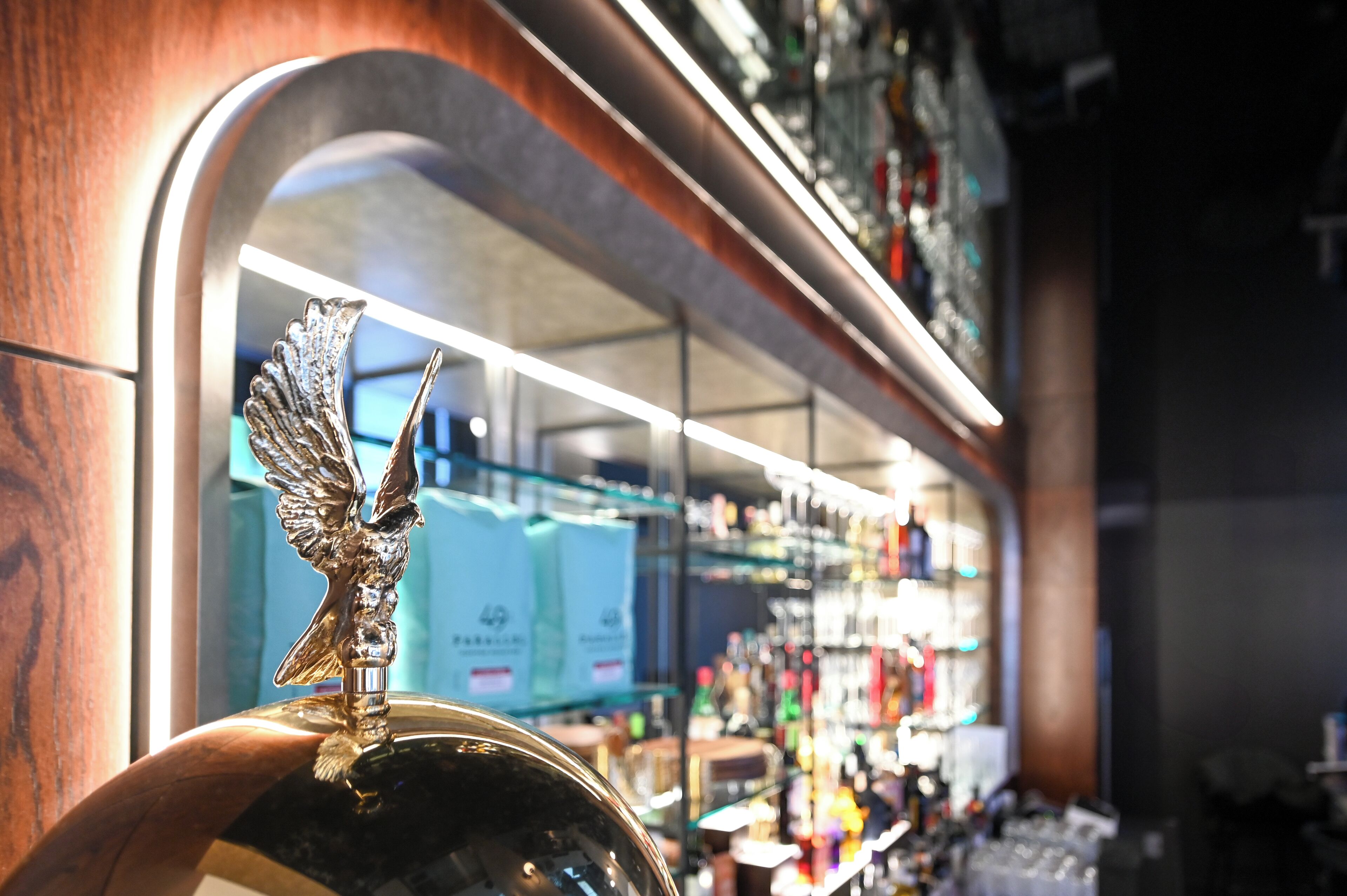 A bar with a decorative metal eagle ornament on the counter.