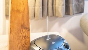 A lamp with a wooden base and a beige lampshade, a mouse, and a curtain in the background. - Auchenflower 1BR Retreat, Parking Close to UQ & M5 (Auchenflower)