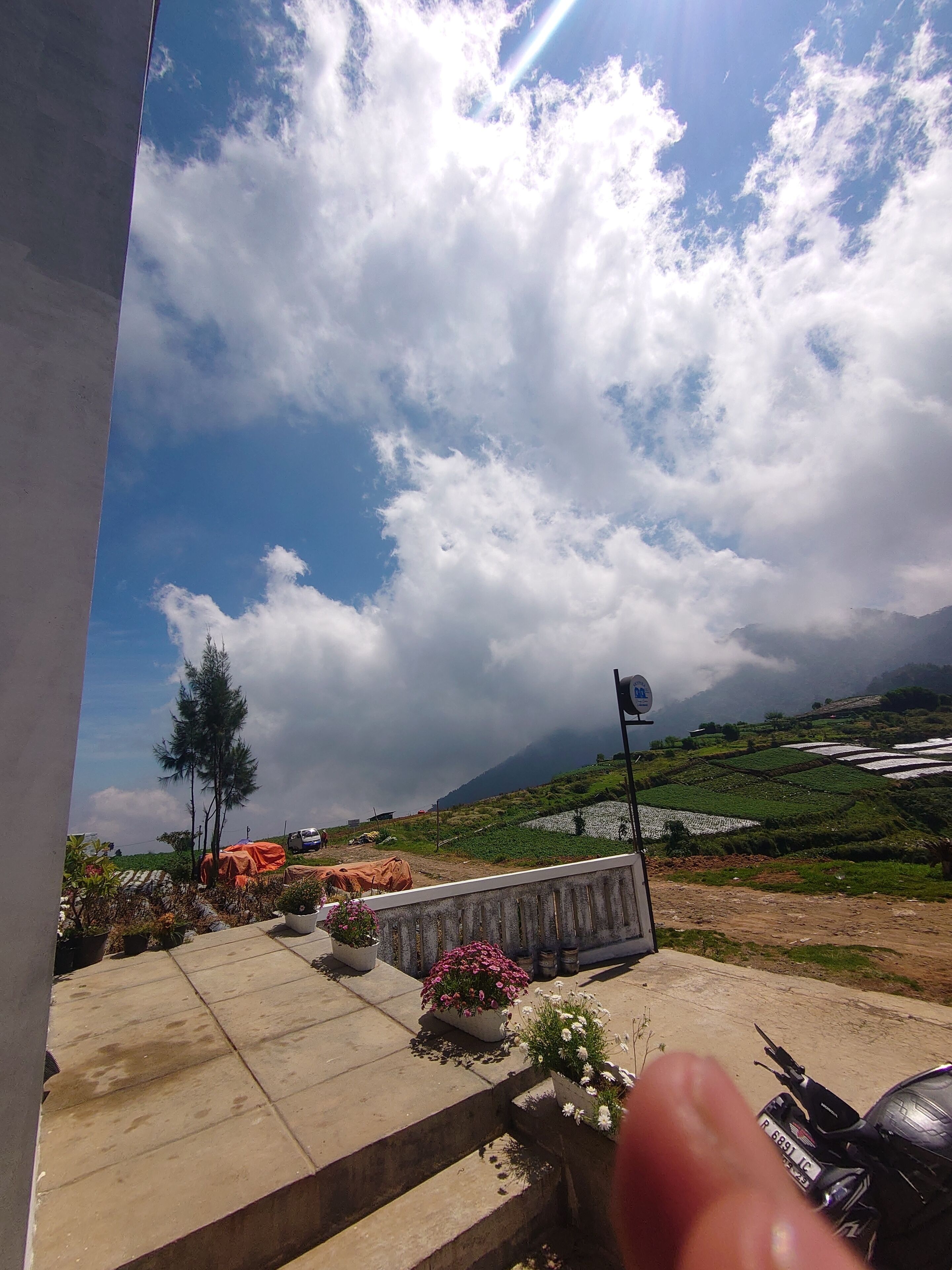 A view of a rural landscape with terraced fields and a clear sky.