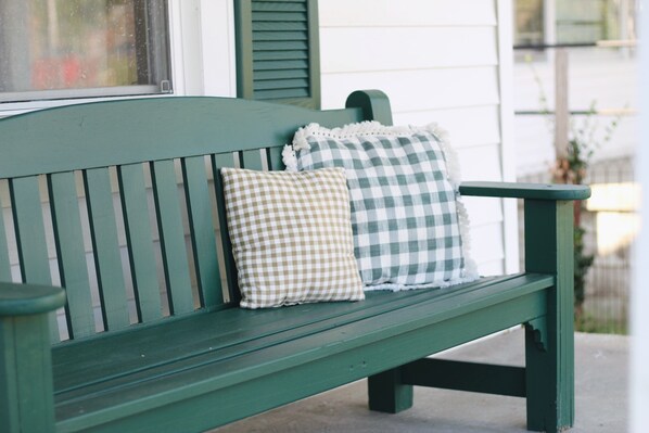 A green wooden bench with checkered cushions. - Cottage In Downtown Georgetown Within Walking Distance Of Shops and Restaurants (Georgetown)