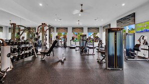A gym with various exercise equipment, including dumbbells, benches, and weight machines. - Big house: private pool | Resort | Near Disney (Kissimmee)