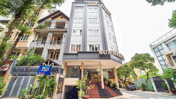 A hotel with a modern facade, multiple balconies, and a prominent entrance with steps.