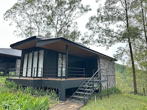 A modern two-story building with a balcony and a staircase leading to the upper floor. - Kanana Retreat Coban Rondo (Pujon)