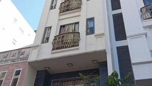 A multi-story building with balconies and a sign that reads "New Era." - New Era Hotel & Apartments (Da Nang)