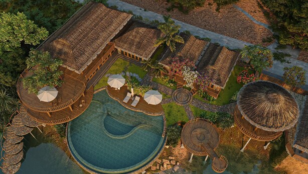 An aerial view of a resort with a central swimming pool, multiple thatched-roof structures, and outdoor seating areas.