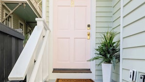 A front porch with a white door, a small staircase, a potted plant, and a mailbox. - Rooftop • Hot Tub • Parking • Walk to King St! (Charleston)