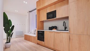 A modern kitchen with wooden cabinets, a microwave, a coffee maker, and a dishwasher. - Sumptuous Apartment - 2br/6p - Center of Paris (Paris)