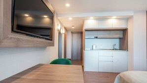 A modern kitchen with white cabinets, a built-in oven, and a coffee maker. - Sunset Residence & Hotel Batumi (Batumi)