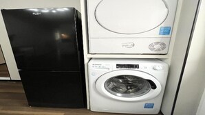 A compact washer and dryer unit with a black refrigerator. - Standard Double Studio (Pembroke Dock)