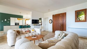 A modern living room with a sofa set, a coffee table, and a TV. - Villa Castille – Pool and Sea View in Lumio, Balagne (LUMIO)