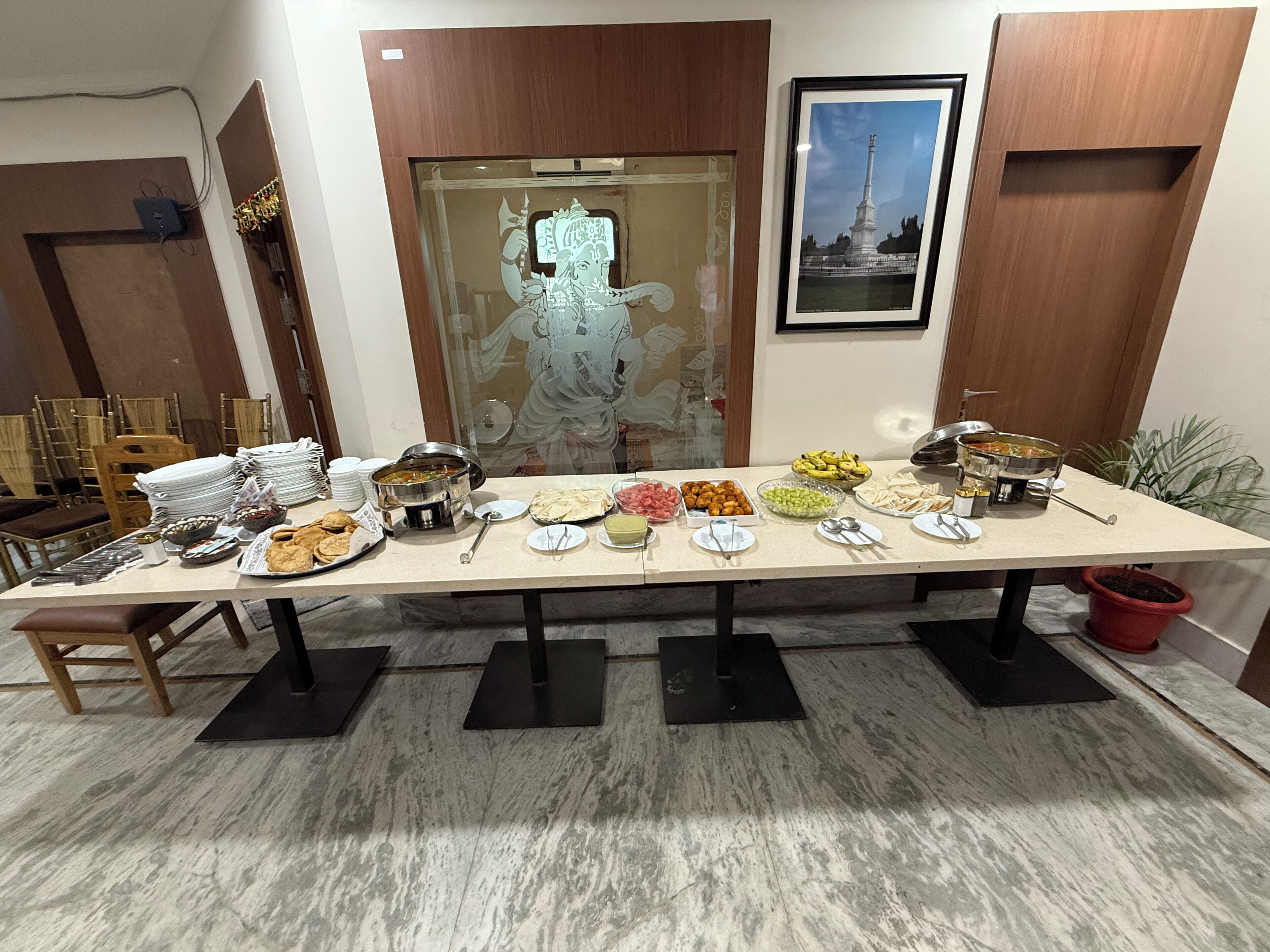 A buffet table with various dishes and a large decorative mirror.
