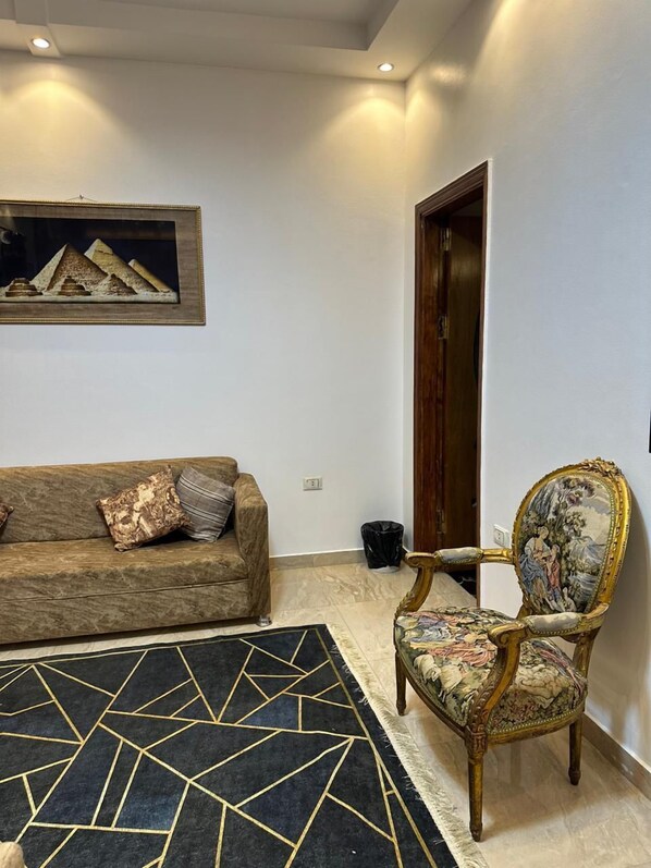 Family Triple Room | Living area | 24-inch LCD TV with digital channels, DVD player, pay movies
