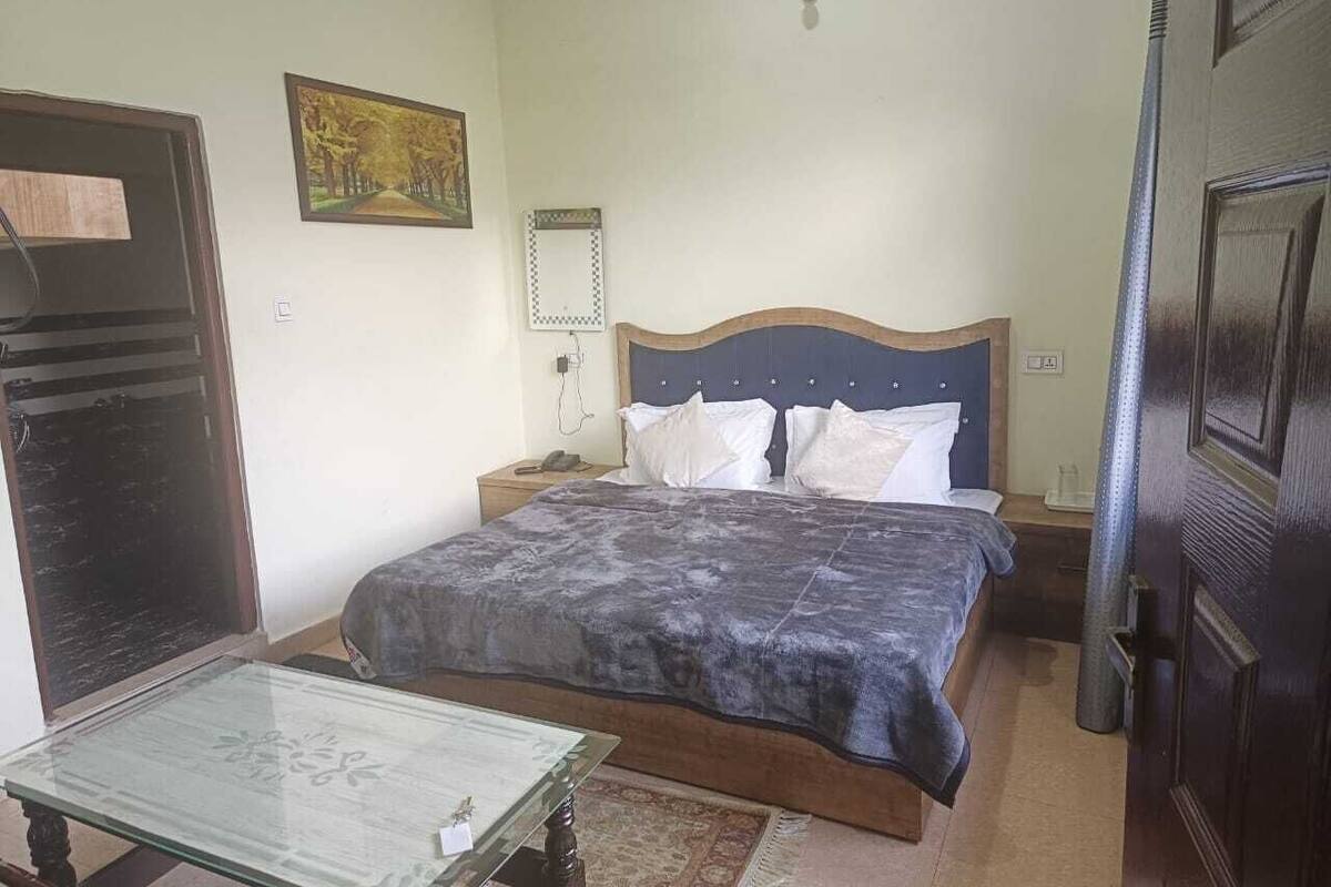 A bedroom with a bed, bedside table, and a nightstand.