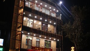 A multi-story building with a sign reading "7th No. Punjab Raso Hotel." - Hotel Shani - Punjabi Rasoi (Palampur)