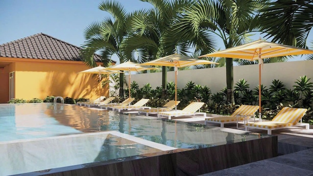 A swimming pool with lounge chairs and umbrellas, surrounded by palm trees. - The Signature Retreat & Pool Phu Quoc (Phu Quoc)