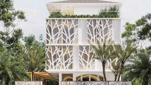 A modern multi-story building with a geometric facade, surrounded by lush greenery and palm trees. - The Signature Retreat & Pool Phu Quoc (Phu Quoc)