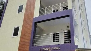 A multi-story building with a modern facade, featuring balconies and large windows. - Karthikeya Guest Inn  (Hyderabad)
