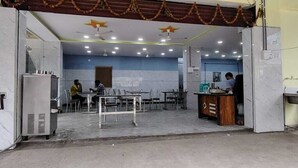 A hotel lobby with a reception desk, seating area, and a large window. - Karthikeya Guest Inn  (Hyderabad)