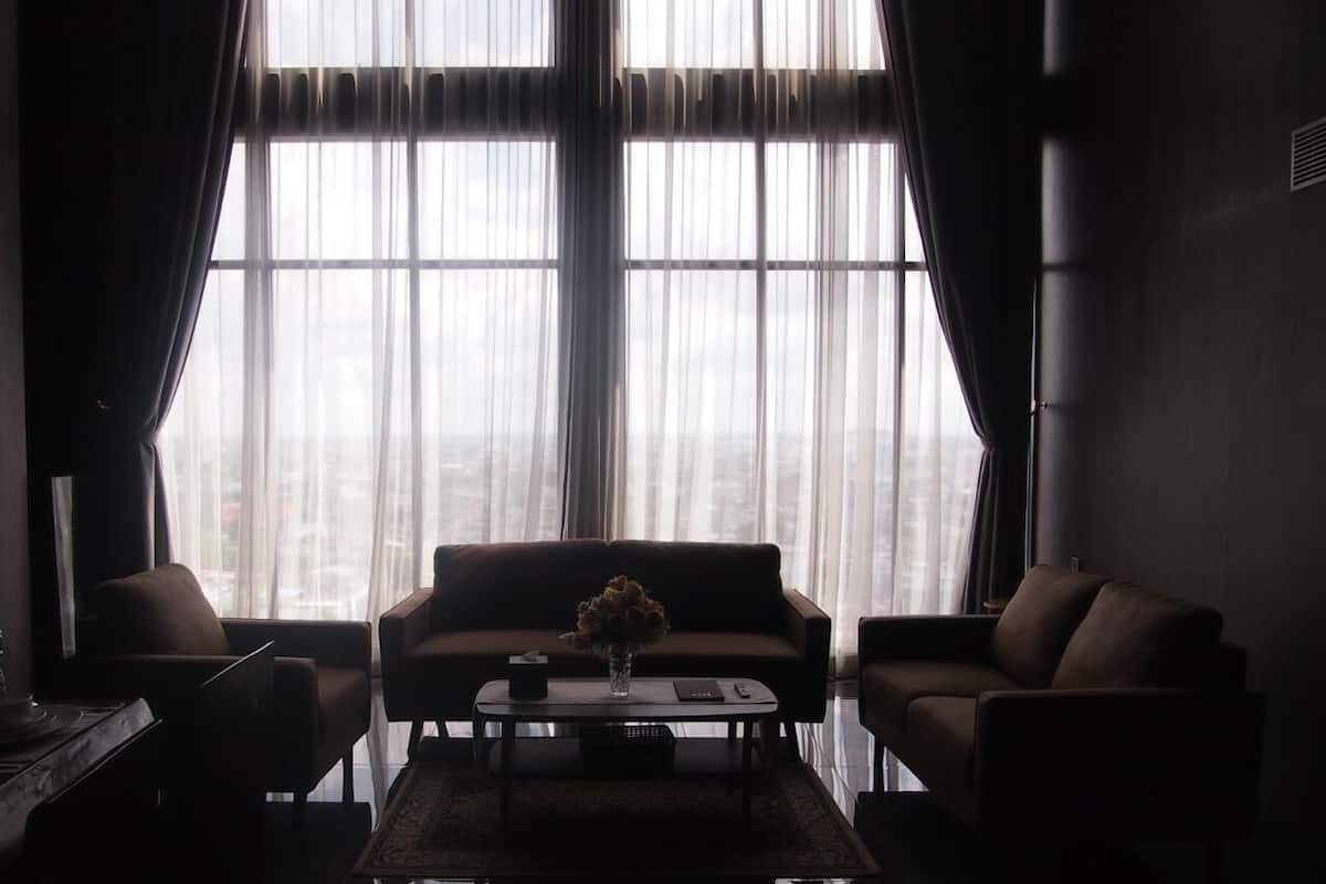 A modern living room with a sofa, armchairs, and a coffee table.