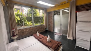 A hotel room with a bed, a window with curtains, a sliding glass door, and a white wardrobe. - Adorable sunny bedroom with AC in Doi Suthep and nimmamhaemin neighborhood. (Muang Chiang mai)