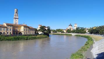 A river with buildings on one side and a tower on the other.